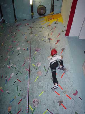 Alex climbs the wall at the rock gym.