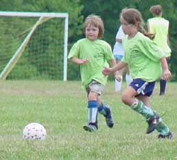 Cate goes for the ball at GO soccer camp.