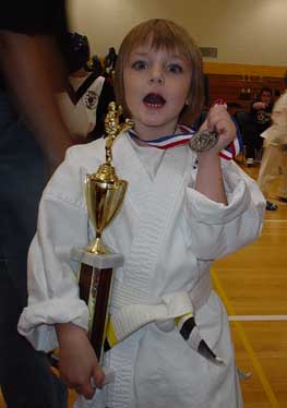 Cate takes 2nd in Kata and 3rd in Kumite at a 2003 tournament.